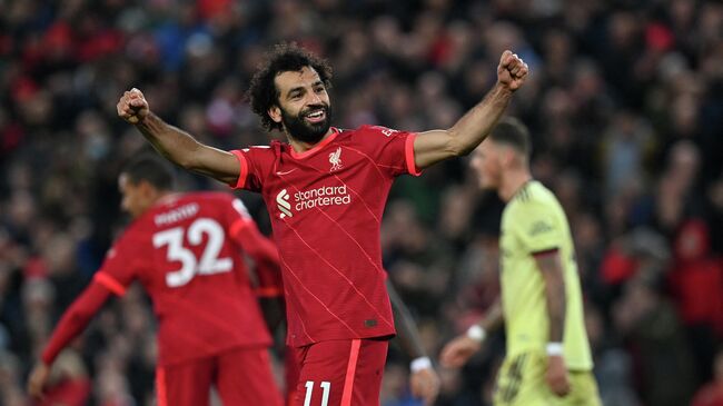 Liverpool's Egyptian midfielder Mohamed Salah celebrates scoring their third goal during the English Premier League football match between Liverpool and Arsenal at Anfield in Liverpool, north west England on November 20, 2021. (Photo by Paul ELLIS / AFP) / RESTRICTED TO EDITORIAL USE. No use with unauthorized audio, video, data, fixture lists, club/league logos or 'live' services. Online in-match use limited to 120 images. An additional 40 images may be used in extra time. No video emulation. Social media in-match use limited to 120 images. An additional 40 images may be used in extra time. No use in betting publications, games or single club/league/player publications. / 