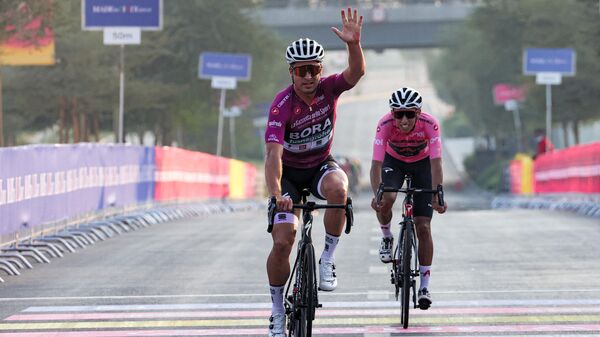 Peter Sagan of Bora–Hansgrohe (L) celebrates after crossing the finish line ahead of Egan Bernal of INEOS Grenadiers during the first-ever Giro d’Italia Criterium race at Expo 2020 in Dubai on November 6, 2021. (Photo by GIUSEPPE CACACE / AFP)
