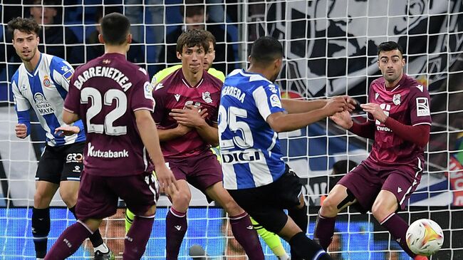 Espanyol's Venezuelan midfielder Yangel Herrera (2R) scores the opening goal during the Spanish league football match between RCD Espanyol and Real Sociedad at the RCDE Stadium in Cornella de Llobregat on November 28, 2021. (Photo by Josep LAGO / AFP)