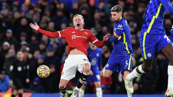 Chelsea's Italian midfielder Jorginho (R) fouls Manchester United's Dutch midfielder Donny van de Beek (C) during the English Premier League football match between Chelsea and Manchester United at Stamford Bridge in London on November 28, 2021. (Photo by Ben STANSALL / AFP) / RESTRICTED TO EDITORIAL USE. No use with unauthorized audio, video, data, fixture lists, club/league logos or 'live' services. Online in-match use limited to 120 images. An additional 40 images may be used in extra time. No video emulation. Social media in-match use limited to 120 images. An additional 40 images may be used in extra time. No use in betting publications, games or single club/league/player publications. / 