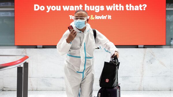 Пассажир в защитном костюме в аэропорту Сиднея