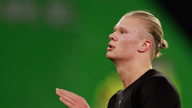 Dortmund's Norwegian forward Erling Braut Haaland celebrates at the end of the German first division Bundesliga football match VfL Wolfsburg v Borussia Dortmund in Wolfsburg, northern Germany, on November 27, 2021. (Photo by Odd ANDERSEN / AFP) / DFL REGULATIONS PROHIBIT ANY USE OF PHOTOGRAPHS AS IMAGE SEQUENCES AND/OR QUASI-VIDEO