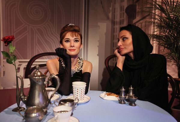 Посетитель позирует с восковой фигурой британской актрисы Одри Хепберн в недавно открывшемся музее восковых фигур мадам Тюссо в Дубае