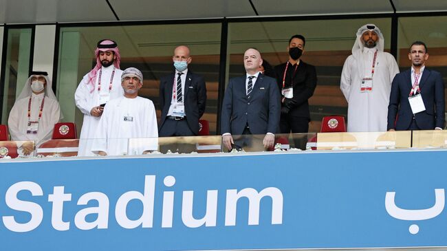 FIFA President Gianni Infantino (C) attends the FIFA Arab Cup 2021 group A football match between Iraq and Oman at the Al-Janoub Stadium in Al-Wakrah on November 30, 2021. (Photo by JACK GUEZ / AFP)