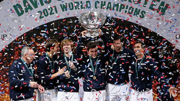 (From L) Russia's Davis Cup captain Shamil Tarpischev, Russia's Daniil Medvedev, Russia's Andrey Rublev, Russia's Aslan Karatsev, Russia's Karen Khachanov and Russia's Evgeny Donskoy celebrate with the trophy after winning the Davis Cup tennis tournament at the Madrid arena in Madrid on December 5, 2021. (Photo by PIERRE-PHILIPPE MARCOU / AFP)