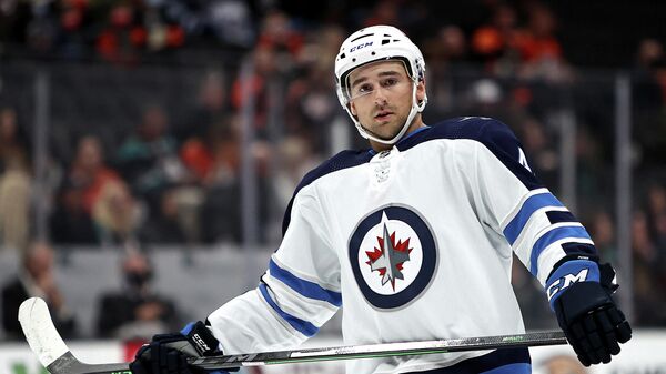 ANAHEIM, CALIFORNIA - OCTOBER 26: Neal Pionk #4 of the Winnipeg Jets looks on during the first period of a game against the Anaheim Ducks at Honda Center on October 26, 2021 in Anaheim, California.   Sean M. Haffey/Getty Images/AFP (Photo by Sean M. Haffey / GETTY IMAGES NORTH AMERICA / Getty Images via AFP)