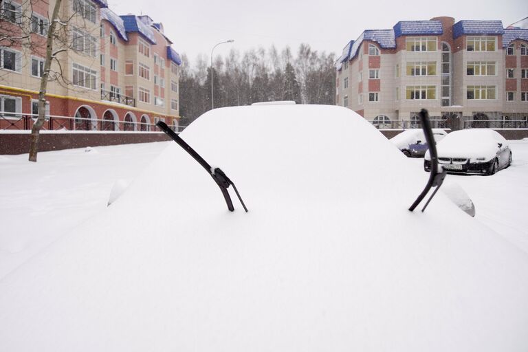 Заснеженный автомобиль в Москве