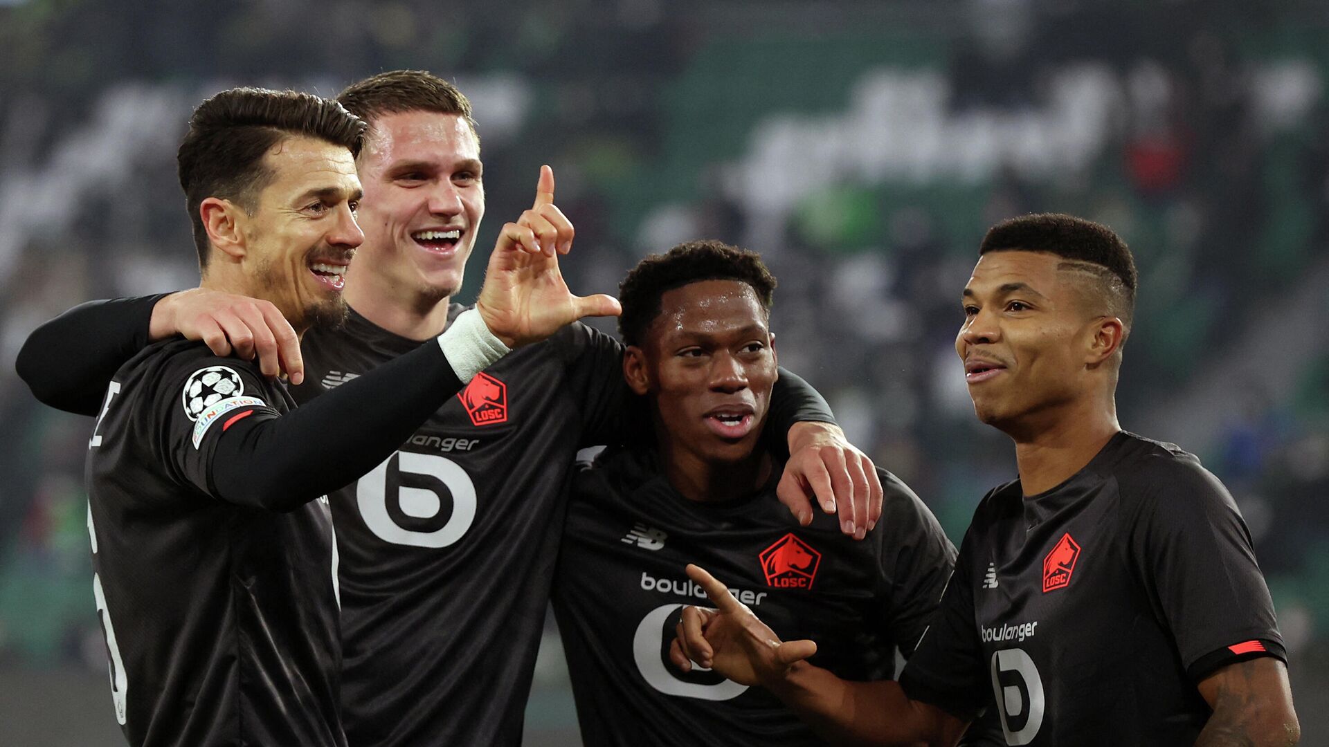 (L-R) Lille's Portuguese defender Jose Fonte, Lille's Dutch defender Sven Botman, Lille's Canadian forward Jonathan David and Lille's Mozambican defender Reinildo Mandava celebrate scoring during the UEFA Champions League group G football match VfL Wolfsburg v Lille LOSC in Wolfsburg, northern Germany on December 8, 2021. (Photo by Ronny HARTMANN / AFP) - РИА Новости, 1920, 09.12.2021