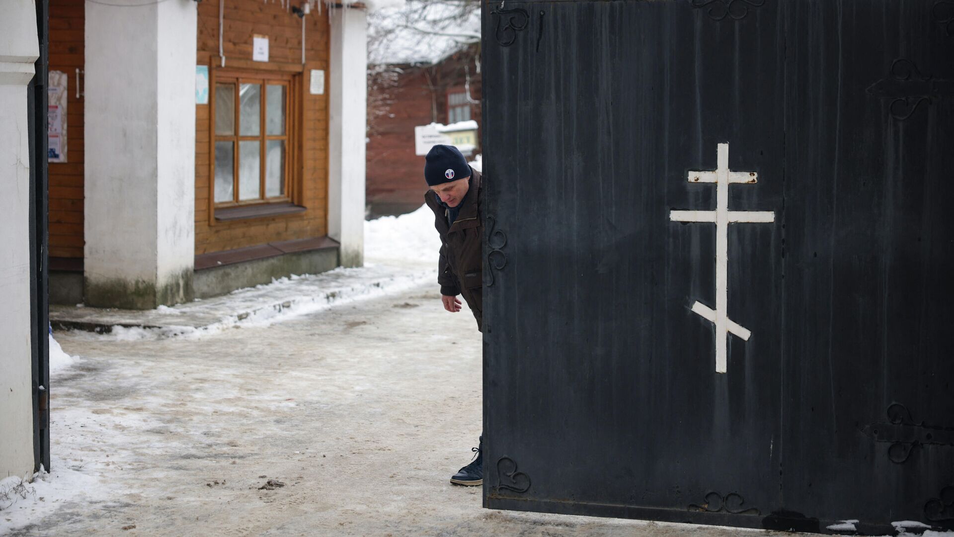 Мужчина закрывает ворота Введенского женского монастыря, где произошел взрыв - РИА Новости, 1920, 13.12.2021