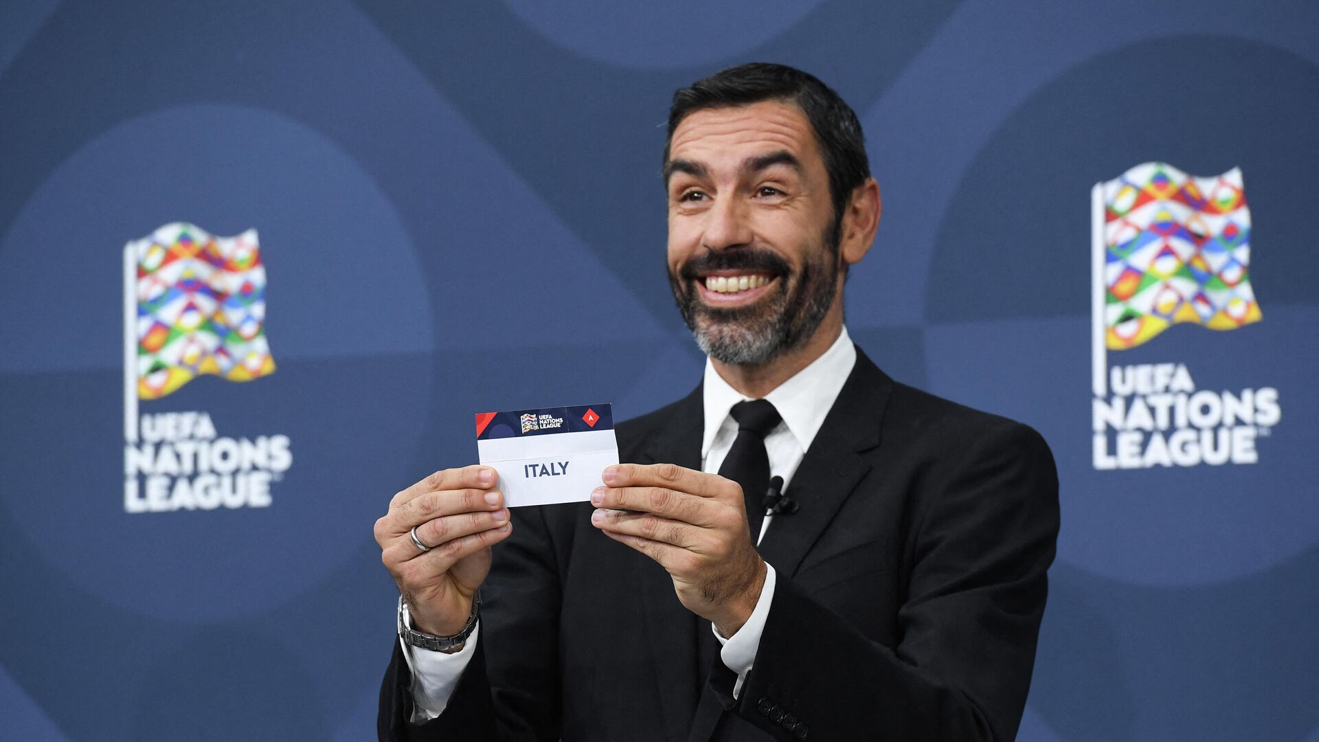 A handout picture taken and made available by the UEFA on December 16, 2021 shows Former French football player Robert Pires holding the slip of Italy during the draw for the 2022 UEFA Nations League football tournament, at the UEFA headquarters, in Nyon. (Photo by various sources / AFP) / RESTRICTED TO EDITORIAL USE - MANDATORY CREDIT AFP PHOTO / UEFA  - NO MARKETING - NO ADVERTISING CAMPAIGNS - DISTRIBUTED AS A SERVICE TO CLIENTS - РИА Новости, 1920, 16.12.2021