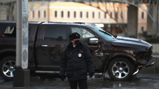 Сотрудник ГИБДД возле автомобиля, попавшего в ДТП