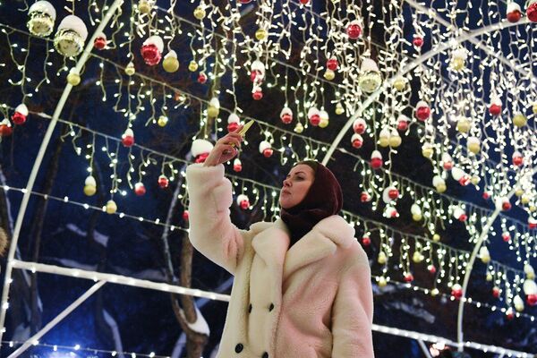 Девушка фотографируется в Театральном сквере в Новосибирске