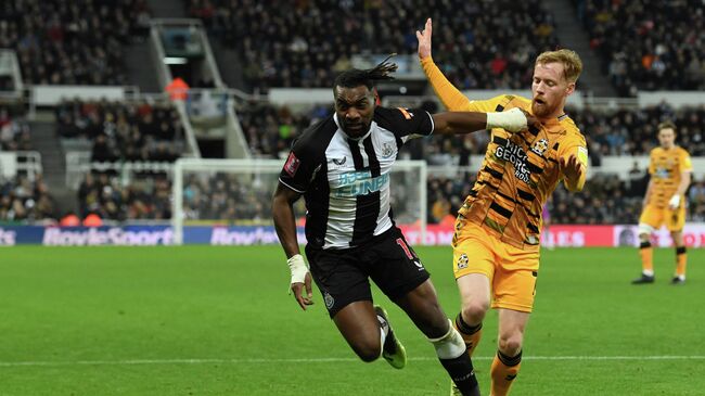 Newcastle United's French midfielder Allan Saint-Maximin (L) vies with Cambridge United's English midfielder James Brophy (R) during the English FA Cup third round football match between Newcastle United and Cambridge United at St James' Park in Newcastle-upon-Tyne, north east England on January 8, 2022. (Photo by Paul ELLIS / AFP) / RESTRICTED TO EDITORIAL USE. No use with unauthorized audio, video, data, fixture lists, club/league logos or 'live' services. Online in-match use limited to 120 images. An additional 40 images may be used in extra time. No video emulation. Social media in-match use limited to 120 images. An additional 40 images may be used in extra time. No use in betting publications, games or single club/league/player publications. / 