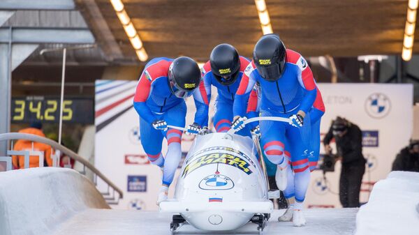 Russia's Maxim Andrianov, Aleksei Pushkarev, Vasiliy Kondratenko and Egor Gryaznov start for the first run of the four-man bobsleigh competition during the IBSF Bob and Skeleton World Cup, the opening event of the Olympic season, at the Olympic sliding track in Innsbruck, Austria, on November 21, 2021. (Photo by Johann GRODER / various sources / AFP) / Austria OUT