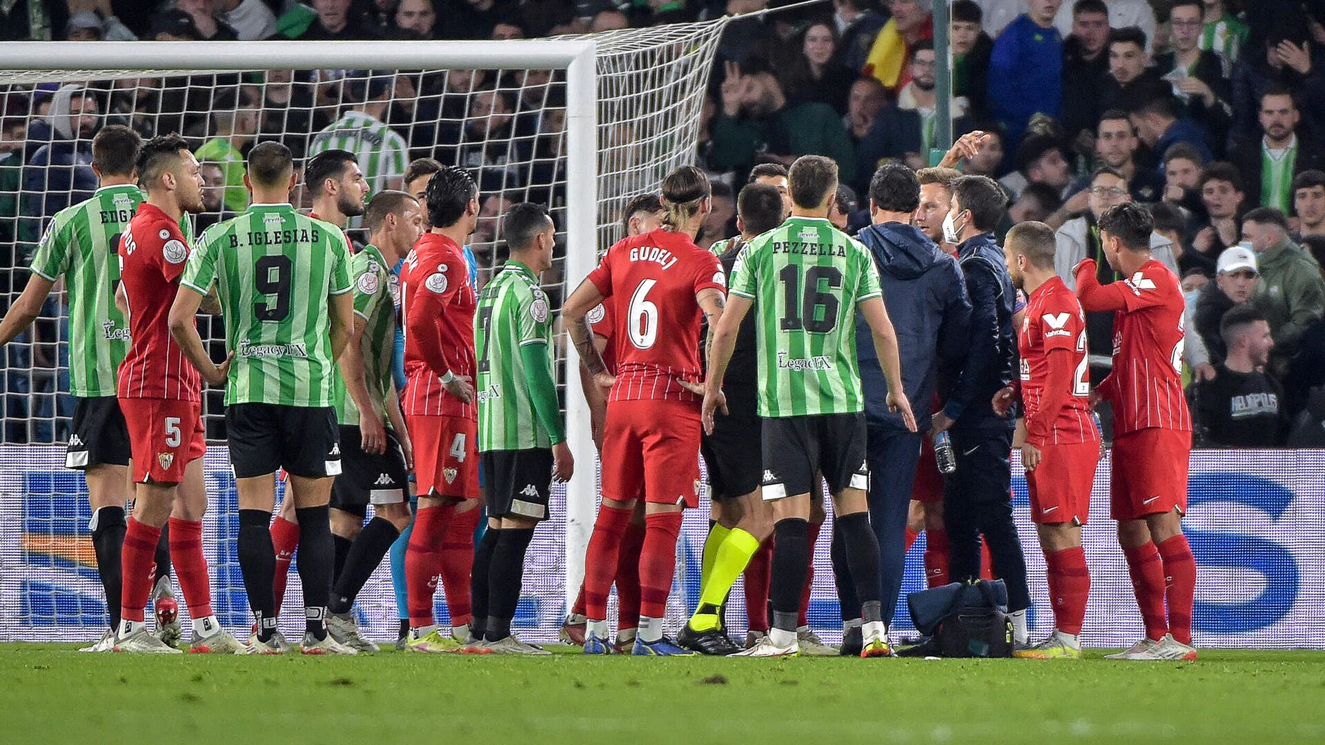 Sevilla's Spanish midfielder Joan Jordan Moreno (C) receives assistance after being hit by an object thrown from the tribunes during the Spanish Copa del Rey (King's Cup) round of 16 first leg football match between Real Betis and Sevilla FC at the Benito Villamarin stadium in Seville on January 15, 2022. - The Copa del Rey match between rivals Sevilla and Real Betis was stopped after Sevilla's Joan Jordan was struck on the head by an object thrown from the crowd. (Photo by CRISTINA QUICLER  - РИА Новости, 1920, 16.01.2022