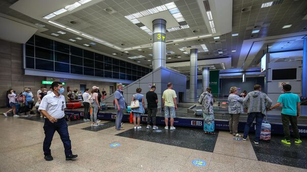 Российские туристы во время получения багажа в международном аэропорту Каира