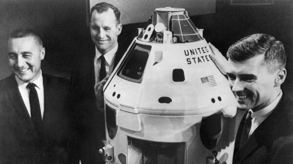 Экипаж космического корабля Апполон-1 фотографируется около его модели в центре Кеннеди 