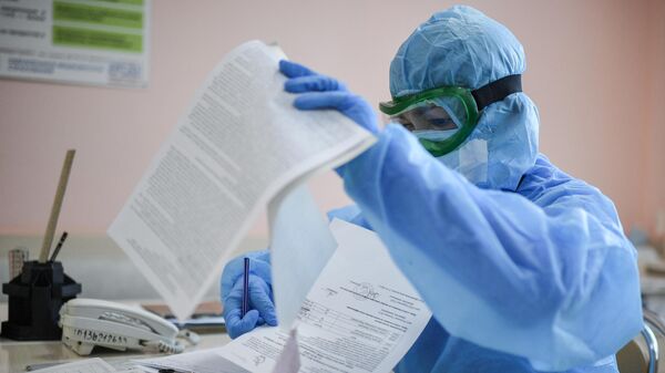 Медицинский работник работает с документами в реанимационном отделении COVID-госпиталя
