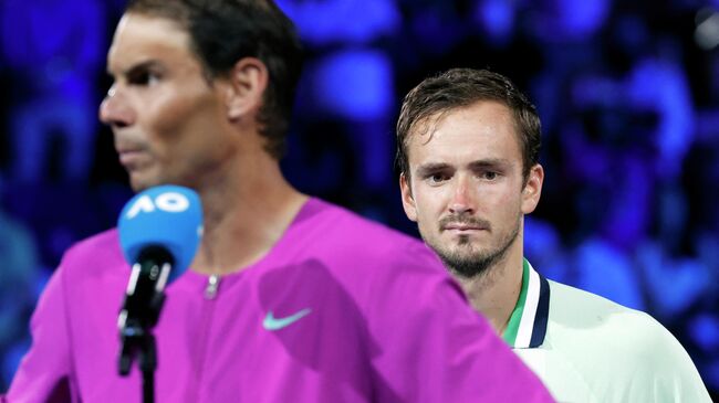 Tennis - Australian Open - Men's Singles Final - Melbourne Park, Melbourne, Australia - January 31, 2022 Spain's Rafael Nadal gives a speech to celebrates winning the men's singles final as Russia's Daniil Medvedev looks on REUTERS/Asanka Brendon Ratnayake