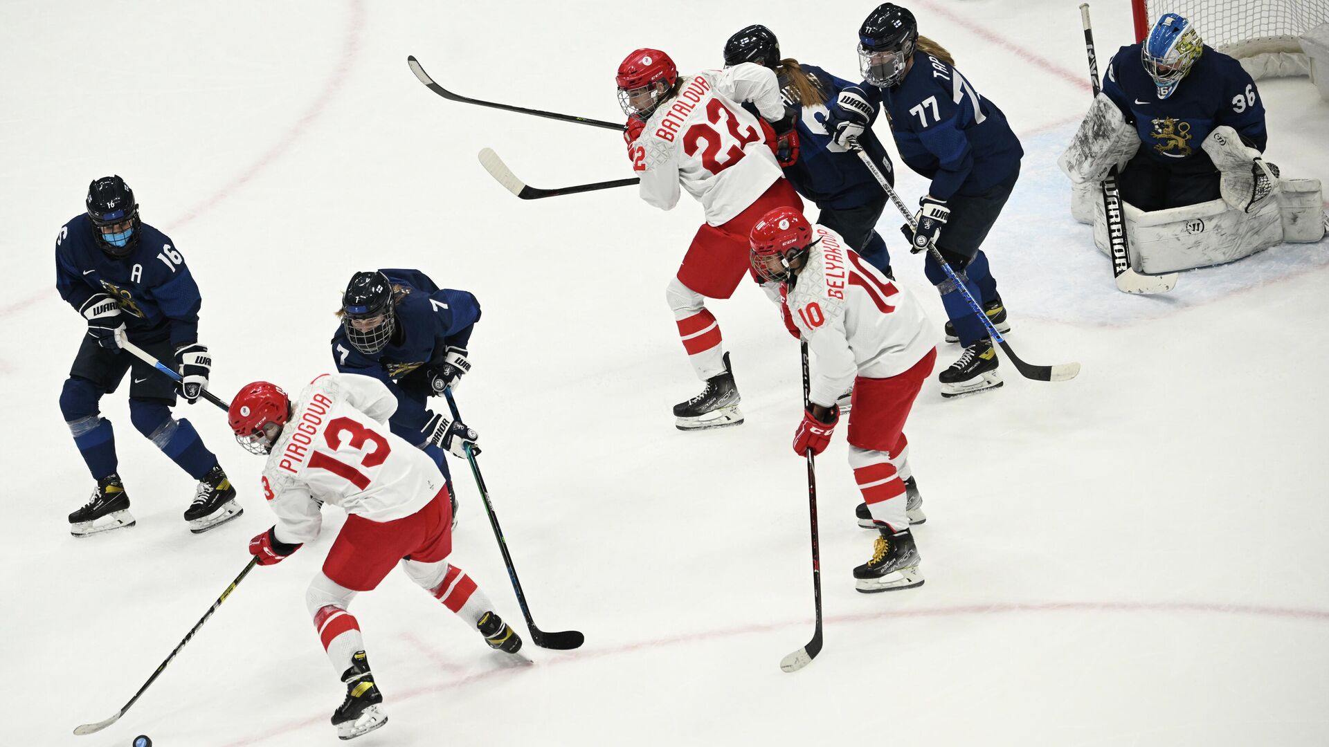 (From L) Finland's Petra Nieminen, Russian Olympic Commitee's Nina Pirogova and Finland's Sanni Rantala go for the puck during the women's preliminary round group A match of the Beijing 2022 Winter Olympic Games ice hockey competition between Finland and players of Russia's Olympic Committee, at the National Indoor Stadium in Beijing on February 8, 2022. (Photo by Anne-Christine POUJOULAT / AFP) - РИА Новости, 1920, 08.02.2022