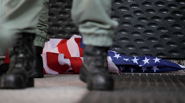 Сотрудник полиции стоит около флага США