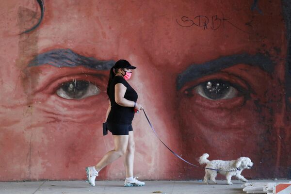 Женщина гуляет с собакой в Лос-Анджелесе