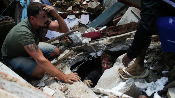 Поиски людей на месте схода оползня в городе Петрополис, Бразилия