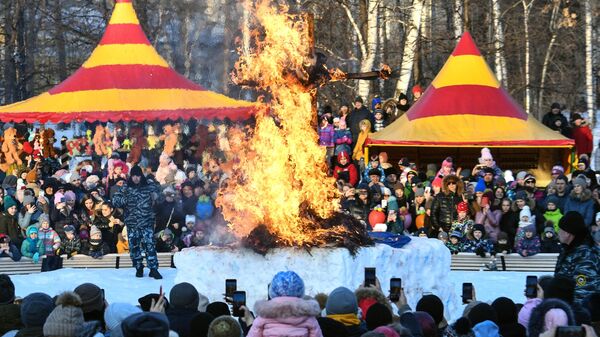 Сжигание чучела во время празднования широкой Масленицы в Центральном парке Новосибирска