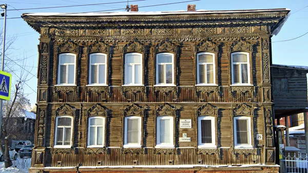 An old wooden house with openwork architraves in the Tatarskaya Sloboda of Tomsk