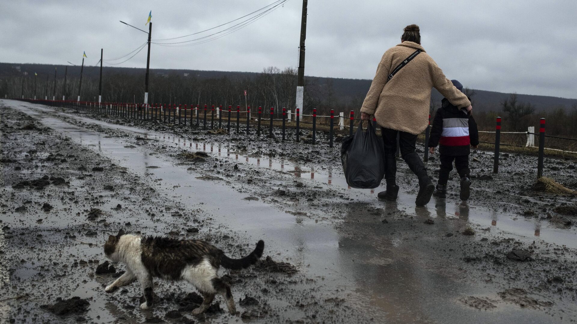 Женщина с ребенком идут по дороге у Станицы Луганская, которая перешла под контроль ЛНР - РИА Новости, 1920, 30.03.2022