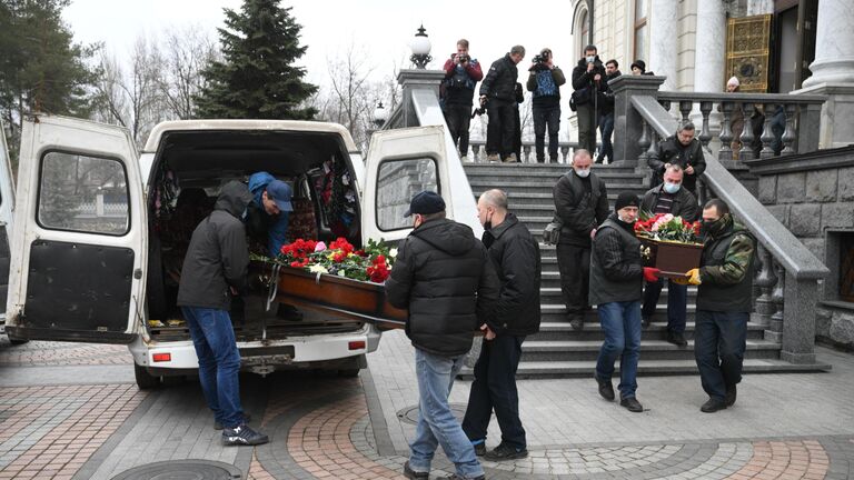 Вынос гробов с телами погибших при обстреле украинскими войсками здания школы в Горловке в ДНР 