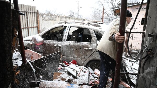 Житель показывает дом в Киевском районе Донецка, поврежденный в результате обстрела