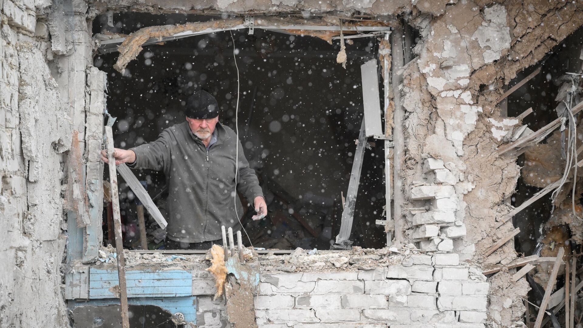 Житель убирает обломки из дома в Кировском районе Донецка, разрушенного в результате обстрела - РИА Новости, 1920, 03.03.2022