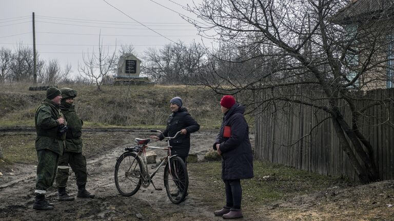 Военнослужащие НМ Луганской народной республики разговаривают с местными жителями в селе Крымское