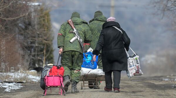 Бойцы Народной милиции ДНР помогают везти вещи жительнице села Новотроицкое Волновахского района