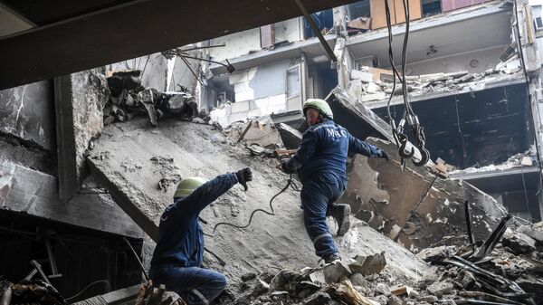 Сотрудники МЧС ДНР разбирают завалы у разрушенных домов в Мариуполе