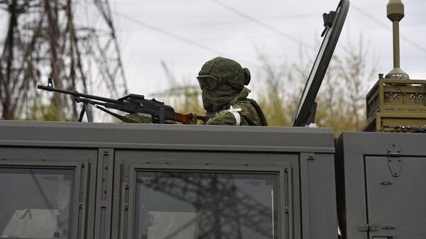 Военнослужащий РФ в бронеавтомобиле на территории теплоэлектростанции в Счастье в ЛНР.