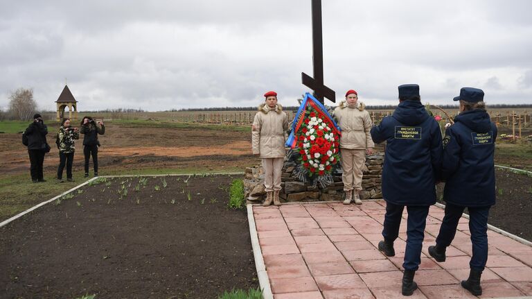 Сотрудники института гражданской защиты ЛНР возлагают цветы к мемориалу Не забудем, не простим! в районе поселка Видное Луганской области в День памяти жертв украинской агрессии