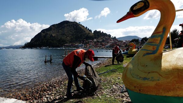 Добровольцы собирают пластиковые бутылки с берегов озера Титикака в Международный день Матери-Земли, Копакабан, Боливия