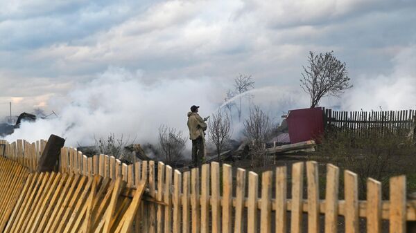 Мужчина тушит пожар в Называевске Омской области