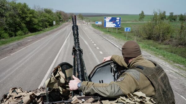 Украинский военнослужащий сидит в бронетранспортере на дороге недалеко от Славянска, Украина