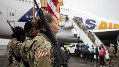 Американские военные во время посадки на самолет для переброски в Европу