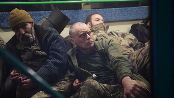 Surrendered Ukrainian soldiers and militants of the Azov nationalist battalion sit on a bus near the pre-trial detention center in Yelenovka.