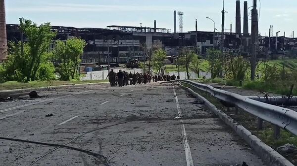 Сдавшиеся в плен украинские военнослужащие и боевики выходят с территории комбината Азовсталь в Мариуполе