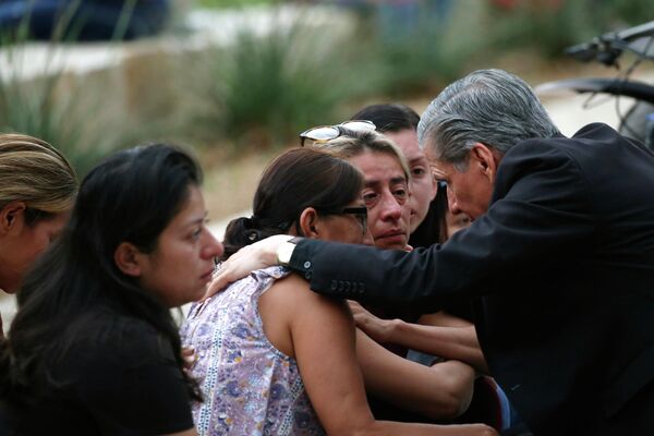 Архиепископ Сан-Антонио Густаво Гарсия-Силлер утешает семьи после массовой стрельбы в начальной школе в Ювалде, штат Техас