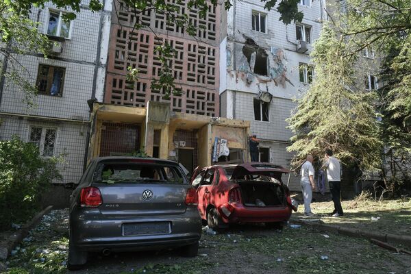Поврежденные автомобили и жилой дом после обстрелов украинскими войсками в Петровском районе Донецка