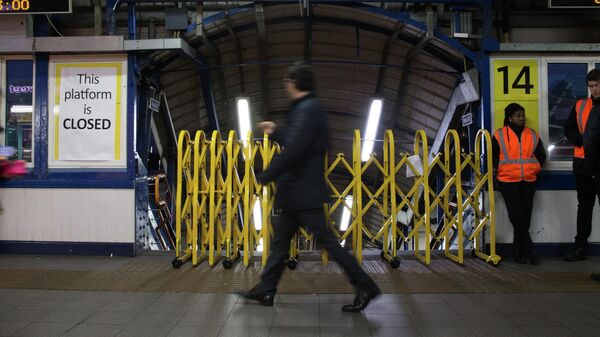 Пассажир проходит мимо закрытого входа на платформу станции Клэпхем-Джанкшен во время забастовки железнодорожников в Лондоне