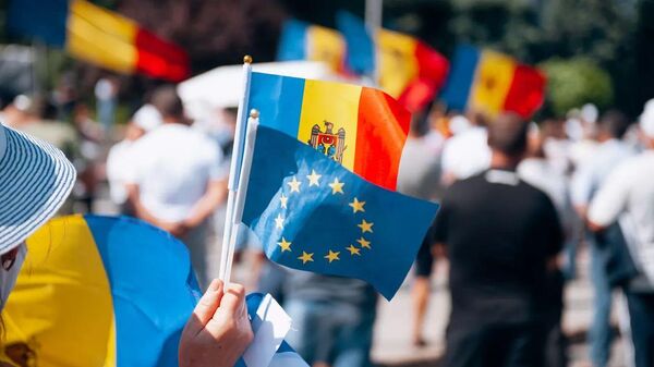 Участник акции с флажками Молдавии и ЕС