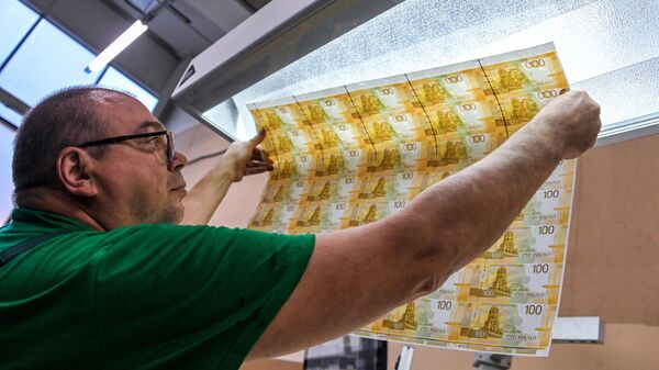 Сотрудник выполняет поэкземплярный контроль новых 100-рублевых денежных купюра на фабрике АО Гознак в Москве