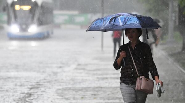 Женщина под зонтом во время дождя